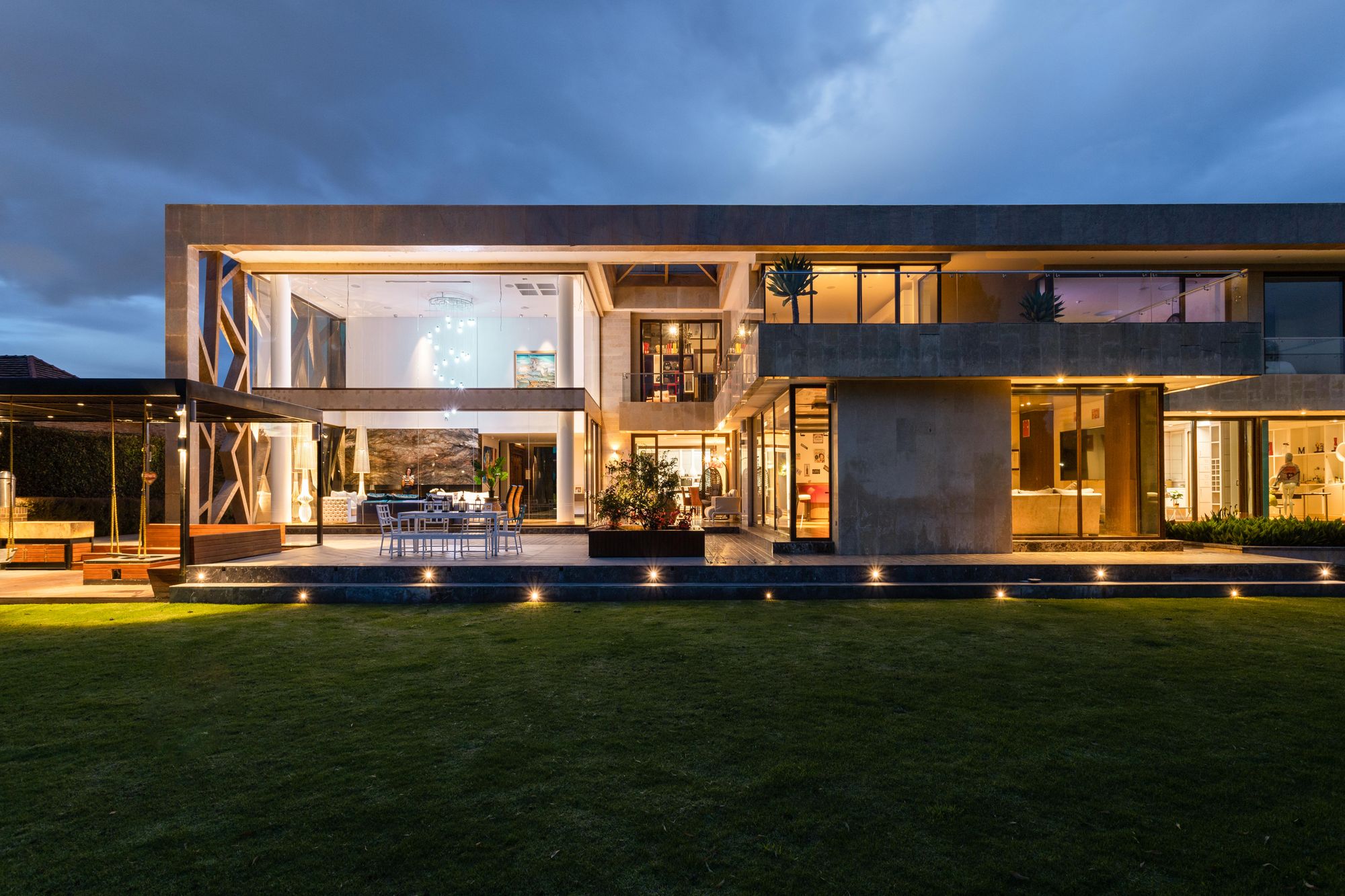 Large contemporary residence illuminated at dusk
